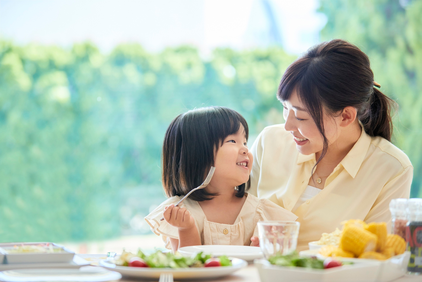 Mom and Daughter Sharing a Joyful Meal